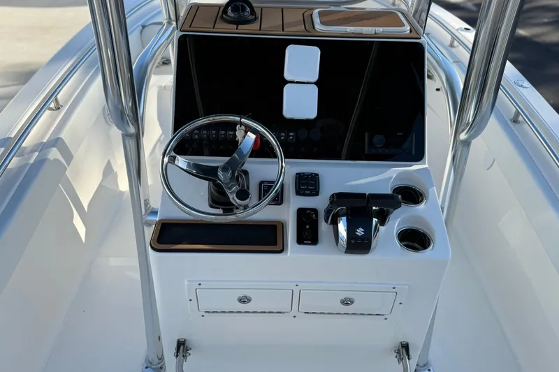 Slide: The Image of 2026 Bulls Bay 255 Center Console boat dashboard with steering wheel and controls. - 6