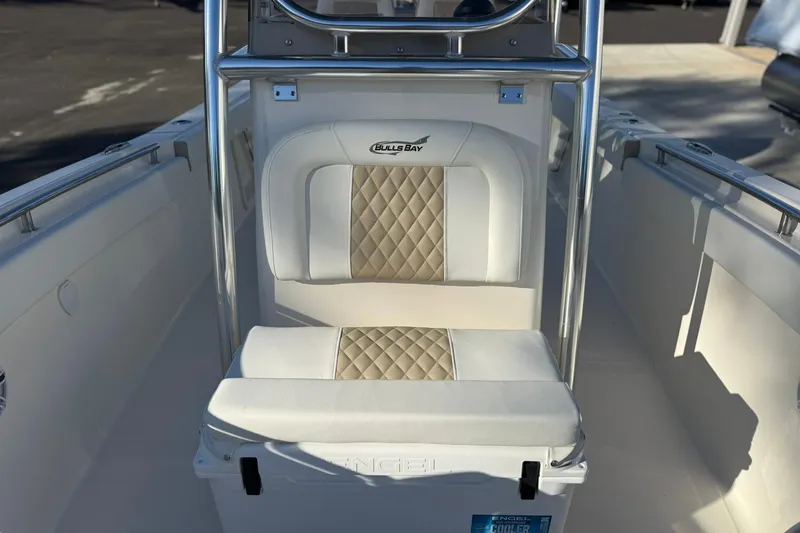 Slide: The Image of 2026 Bulls Bay 255 Center Console boat interior with cushioned seating and stainless steel frame. - 8