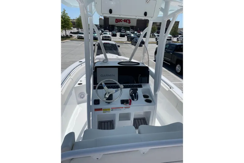 Slide: The Image of 2023 Sea Hunt Ultra 234 boat interior with Garmin navigation system, parked near Buc-ee's. - 2