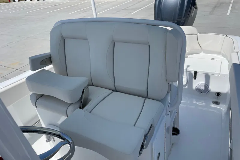 Slide: The Image of 2023 Sea Hunt Ultra 234 boat interior with cushioned seating and steering wheel. - 3