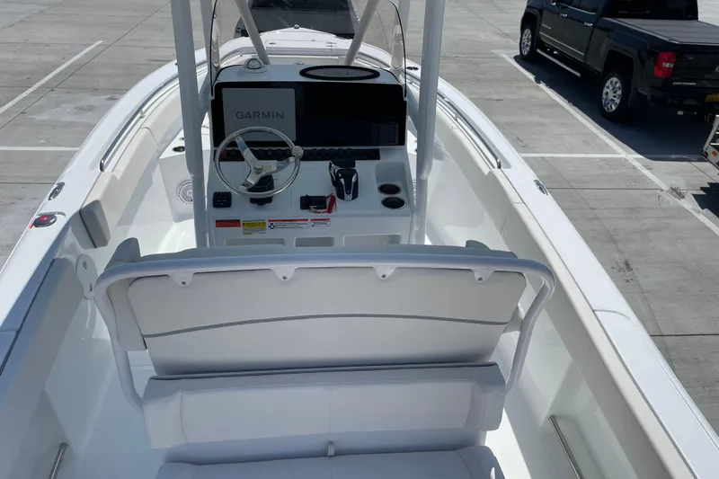 Slide: The Image of 2023 Sea Hunt Ultra 234 boat interior with Garmin navigation system and seating. - 4