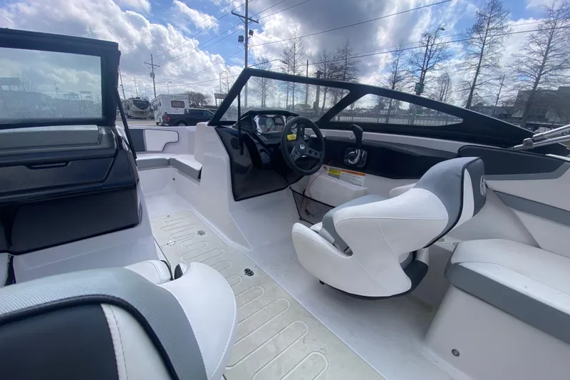 Slide: The Image of Interior of a 2018 Scarab 215 G boat with modern seating and steering wheel. - 12