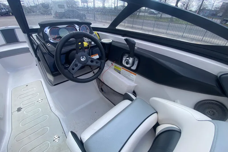 Slide: The Image of 2018 Scarab 215 G boat interior with steering wheel and dashboard controls. - 13