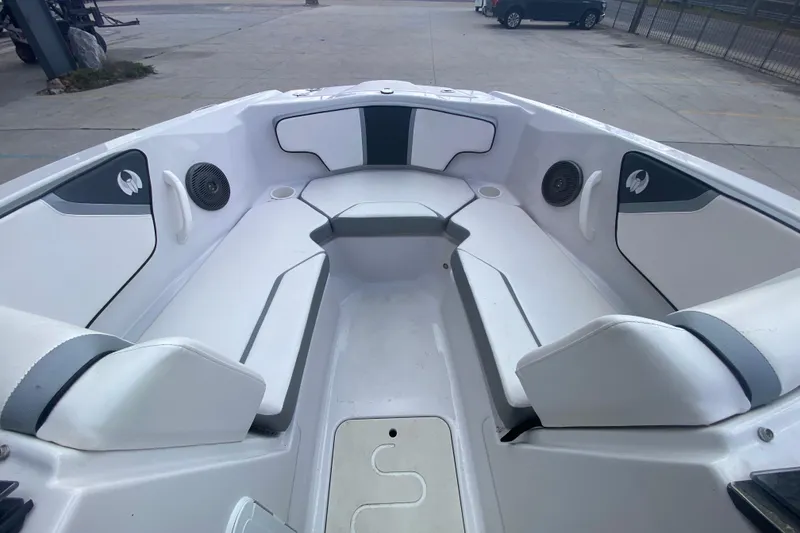 Slide: The Image of 2018 Scarab 215 G boat interior with white seating and speakers. - 15