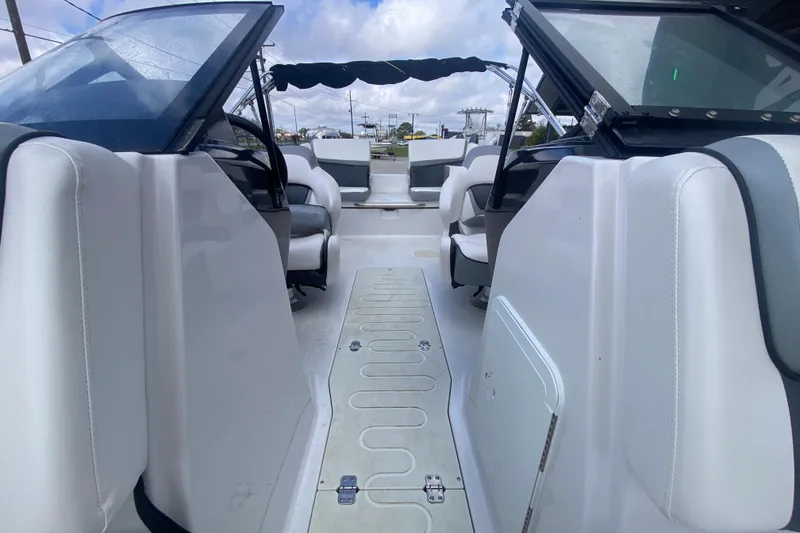 Slide: The Image of 2018 Scarab 215 G boat interior with white seating and open deck layout. - 16