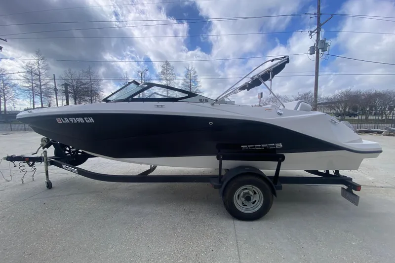 Slide: The Image of 2018 Scarab 215 G boat on trailer under cloudy sky. - 20