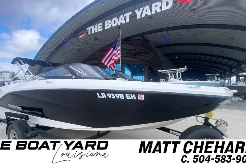 Slide: The Image of 2018 Scarab 215 G boat at The Boat Yard, Louisiana, with American flag. - 22