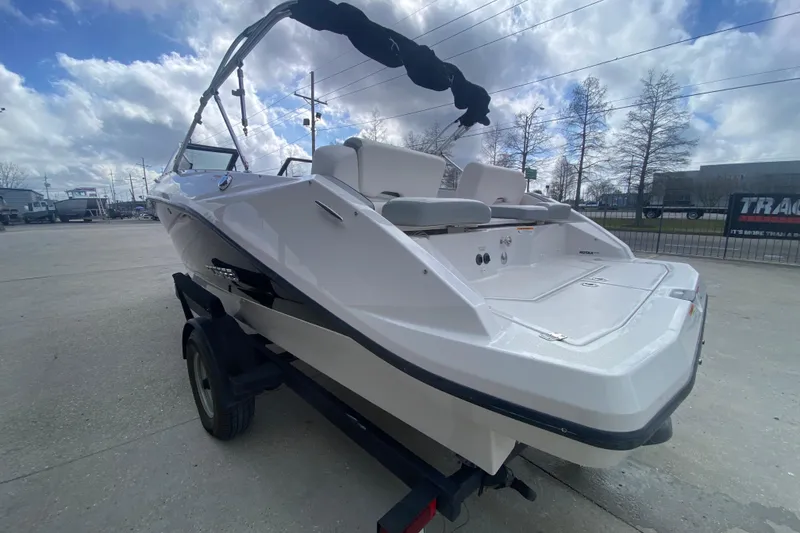 Slide: The Image of 2018 Scarab 215 G boat on trailer, rear view, under cloudy sky. - 3