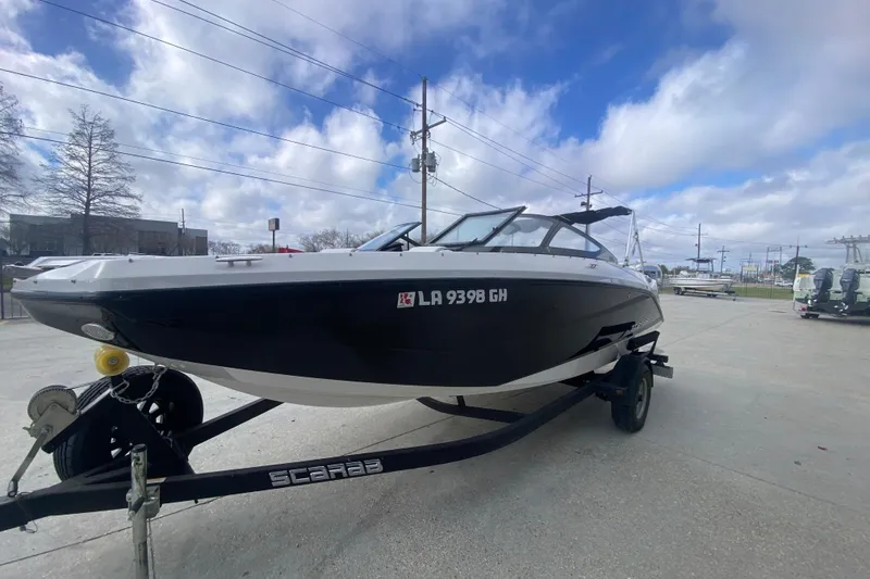 Slide: The Image of 2018 Scarab 215 G boat on trailer under cloudy sky. - 4