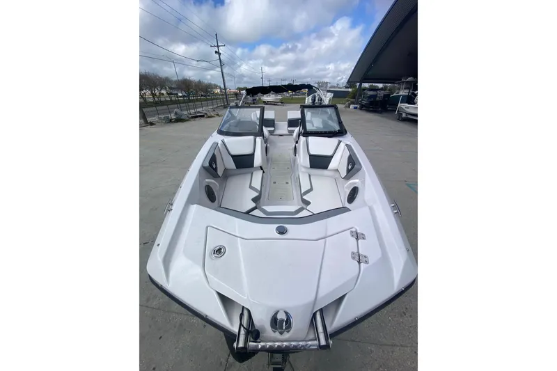 Slide: The Image of 2018 Scarab 215 G boat with sleek design, white interior, and modern seating arrangement. - 7