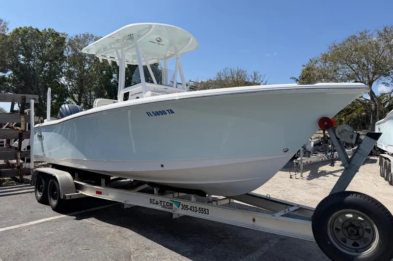 The Image of 2021 Sea Hunt Ultra 234 boat on trailer, parked outdoors. - 0