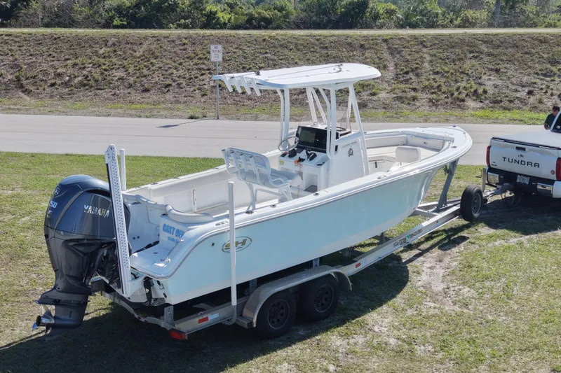 Slide: The Image of 2021 Sea Hunt Ultra 234 boat on trailer, attached to a Tundra truck. - 11