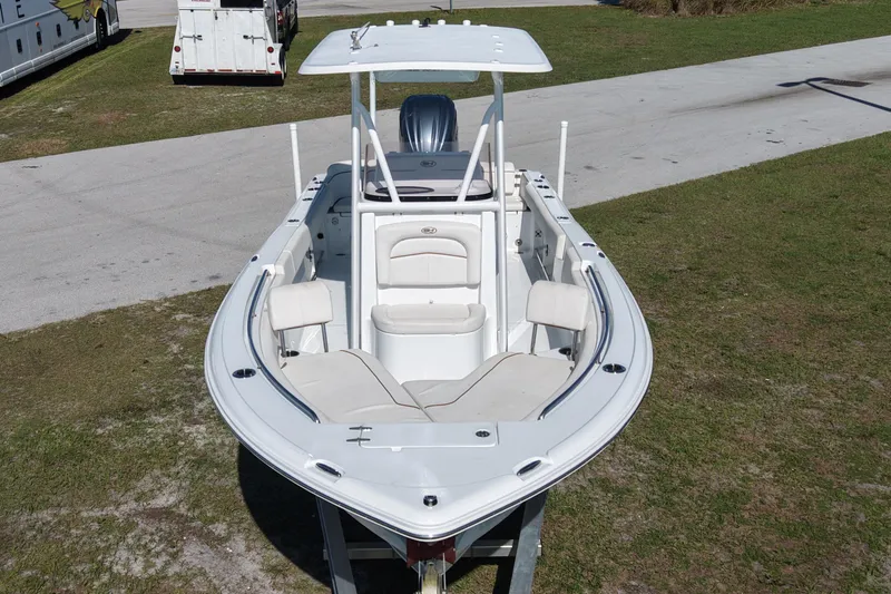 Slide: The Image of 2021 Sea Hunt Ultra 234 boat with white seating and T-top on display. - 13