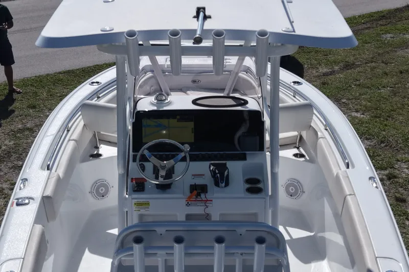 Slide: The Image of 2021 Sea Hunt Ultra 234 boat cockpit with steering wheel and navigation system. - 14