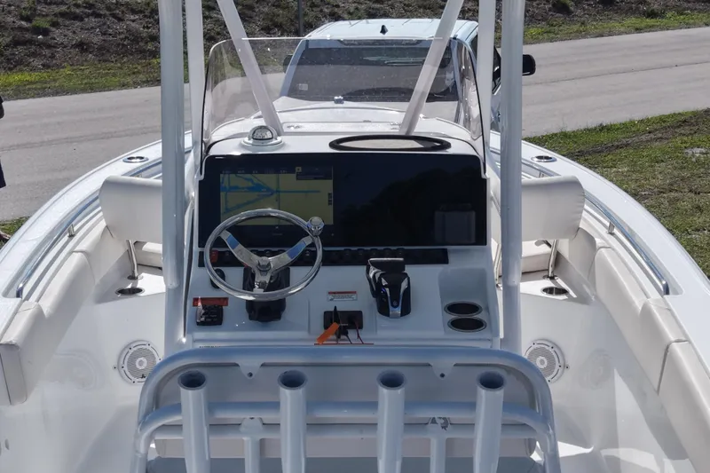 Slide: The Image of 2021 Sea Hunt Ultra 234 boat dashboard with steering wheel and navigation display. - 15