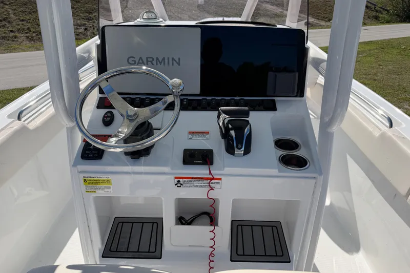 Slide: The Image of 2021 Sea Hunt Ultra 234 boat console with Garmin display and steering wheel. - 16