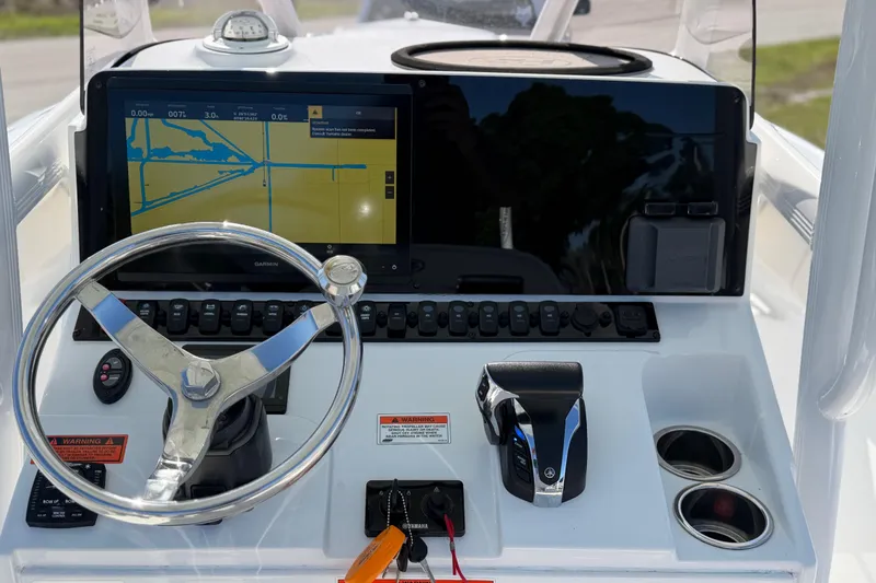 Slide: The Image of 2021 Sea Hunt Ultra 234 boat dashboard with Garmin navigation display and steering wheel. - 17