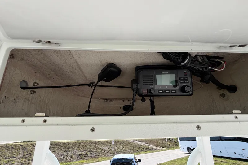 Slide: The Image of 2021 Sea Hunt Ultra 234 boat with Garmin marine radio installed in storage compartment. - 21