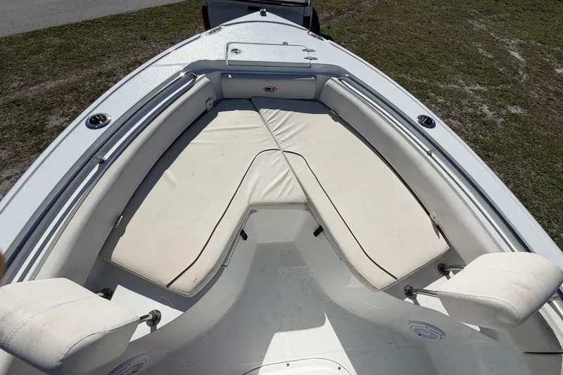 Slide: The Image of 2021 Sea Hunt Ultra 234 boat with cushioned seating in the bow area. - 23