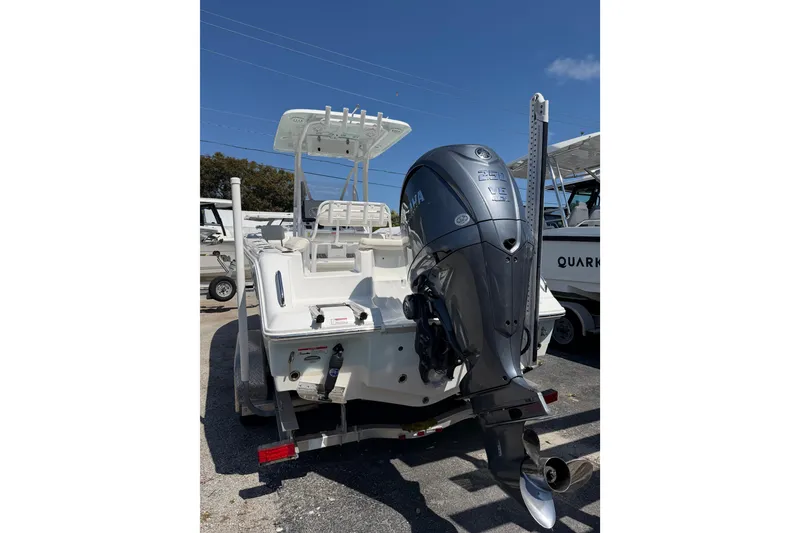 Slide: The Image of 2021 Sea Hunt Ultra 234 boat with Yamaha outboard motor, parked on a trailer. - 3
