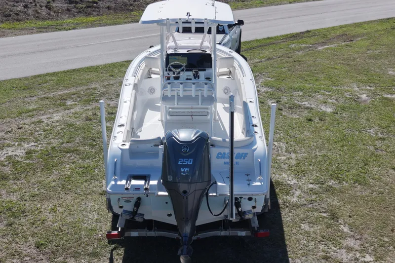 Slide: The Image of 2021 Sea Hunt Ultra 234 boat with Yamaha 250 engine, parked on grass. - 7