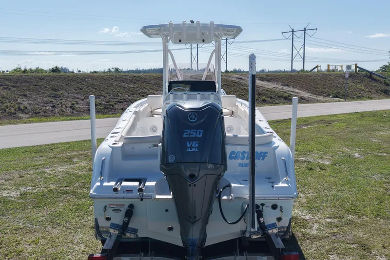 Slide: The Image of 2021 Sea Hunt Ultra 234 boat with Yamaha 250 V6 engine, parked on grass. - 8