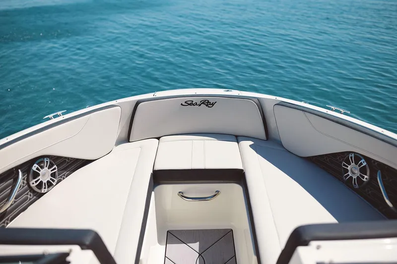 Slide: The Image of Manufacturer Provided Image: 2025 Sea Ray SPX 210 OB boat interior with white seating and blue water background. - 2