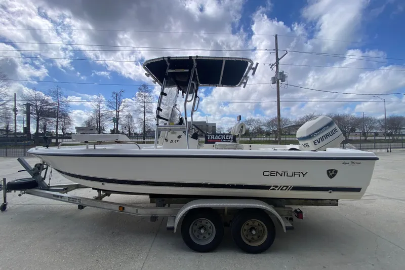 Slide: The Image of 2002 Century 2101 Bay Boat on trailer under cloudy sky. - 10