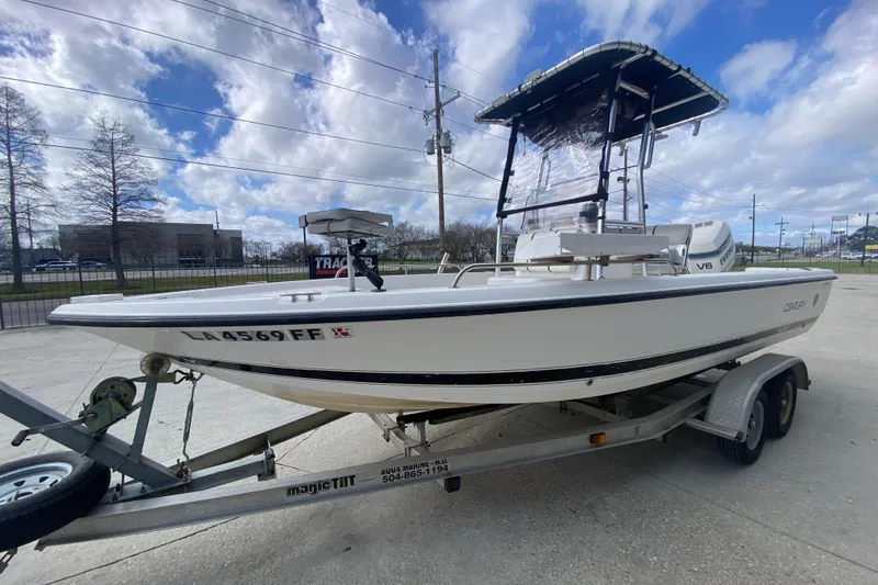 Slide: The Image of 2002 Century 2101 Bay Boat on trailer under cloudy sky. - 11
