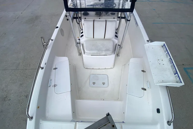 Slide: The Image of 2002 Century 2101 Bay Boat interior with seating and storage compartments. - 13