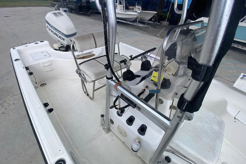 Slide: The Image of 2002 Century 2101 Bay Boat interior with Evinrude outboard motor, featuring seating and controls. - 14