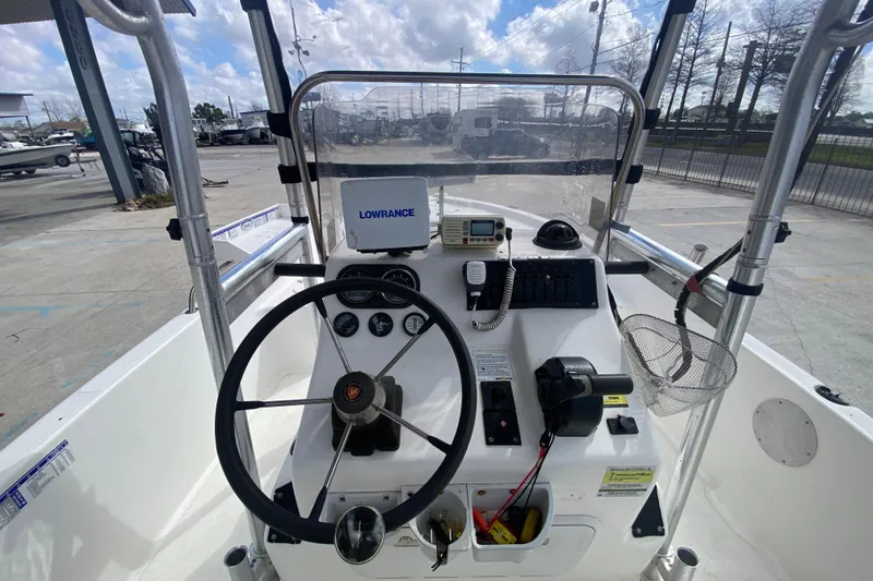 Slide: The Image of 2002 Century 2101 Bay Boat cockpit with steering wheel and navigation equipment. - 19
