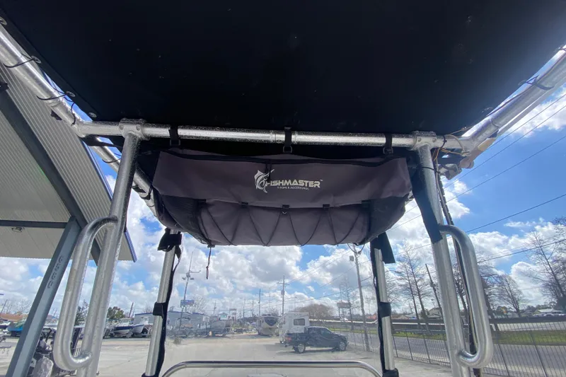 Slide: The Image of 2002 Century 2101 Bay Boat with Fishmaster T-top under blue sky. - 20