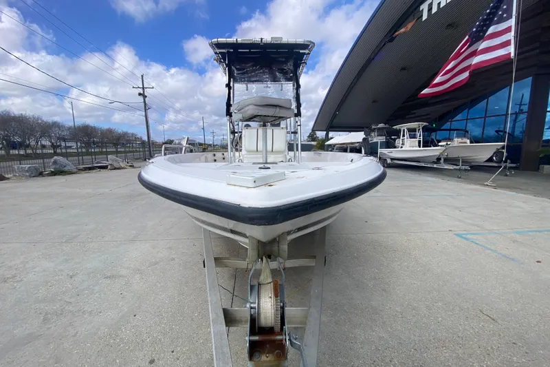 Slide: The Image of 2002 Century 2101 Bay Boat on trailer, displayed outdoors with American flag. - 3