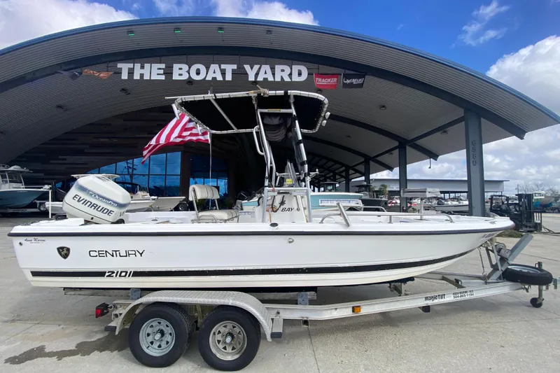 Slide: The Image of 2002 Century 2101 Bay Boat on trailer at The Boat Yard, featuring Evinrude engine. - 7