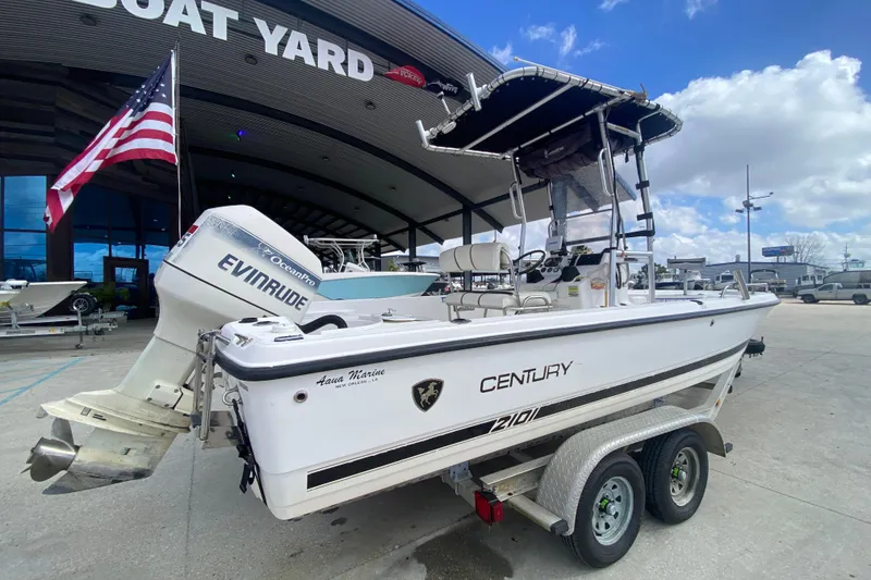 Slide: The Image of 2002 Century 2101 Bay Boat with Evinrude engine at a boat yard. - 8
