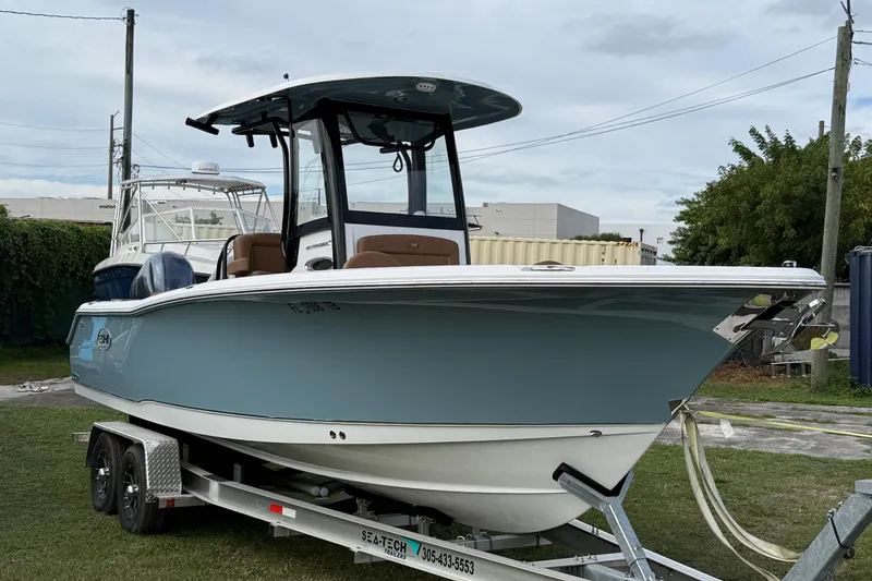 Slide: The Image of 2022 Sea Hunt Ultra 265 SE boat on trailer, parked outdoors. - 2