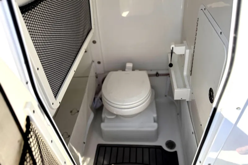 Slide: The Image of 2022 Sea Hunt Ultra 265 SE boat interior with compact marine toilet. - 20
