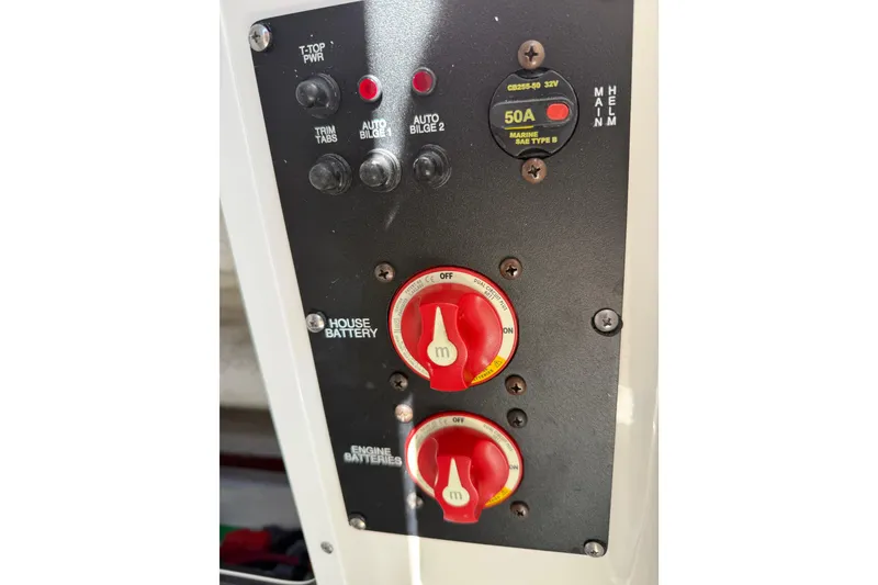 Slide: The Image of Control panel of 2022 Sea Hunt Ultra 265 SE boat with battery switches and circuit breaker. - 21