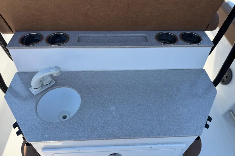 Slide: The Image of 2022 Sea Hunt Ultra 265 SE boat console with sink and cup holders. - 22