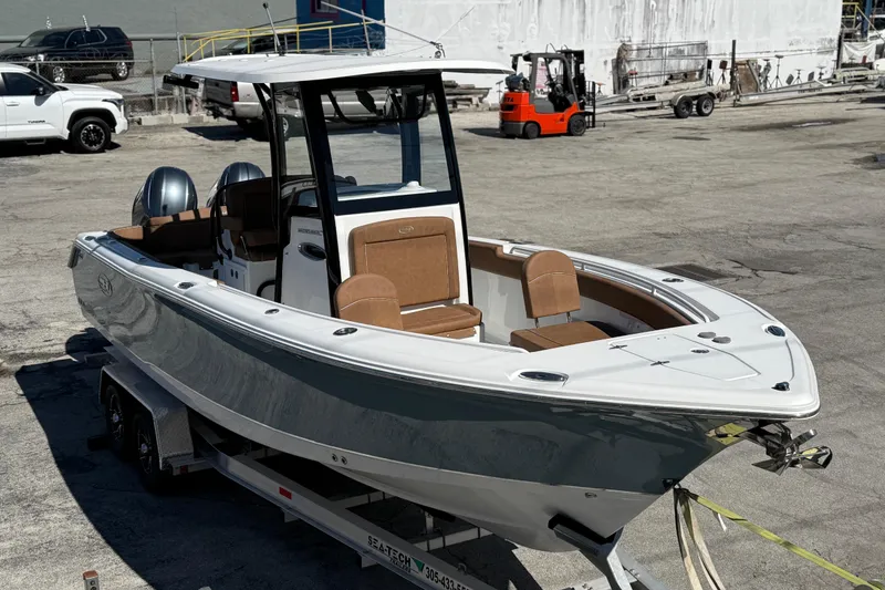 Slide: The Image of 2022 Sea Hunt Ultra 265 SE boat on trailer in industrial setting. - 4
