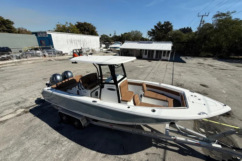 Slide: The Image of 2022 Sea Hunt Ultra 265 SE boat on trailer in a marina parking lot. - 5