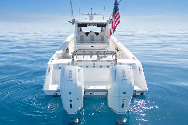 Slide: The Image of 2024 Solace 41 CS boat with dual engines on calm ocean water. - 12