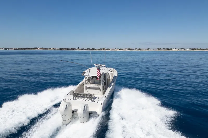 Slide: The Image of 2024 Solace 41 CS boat cruising on open water with clear blue sky. - 16