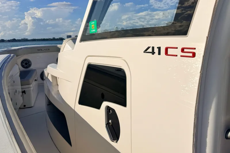 Slide: The Image of 2024 Solace 41 CS boat, sleek design, white exterior, ocean backdrop, sunny day. - 19
