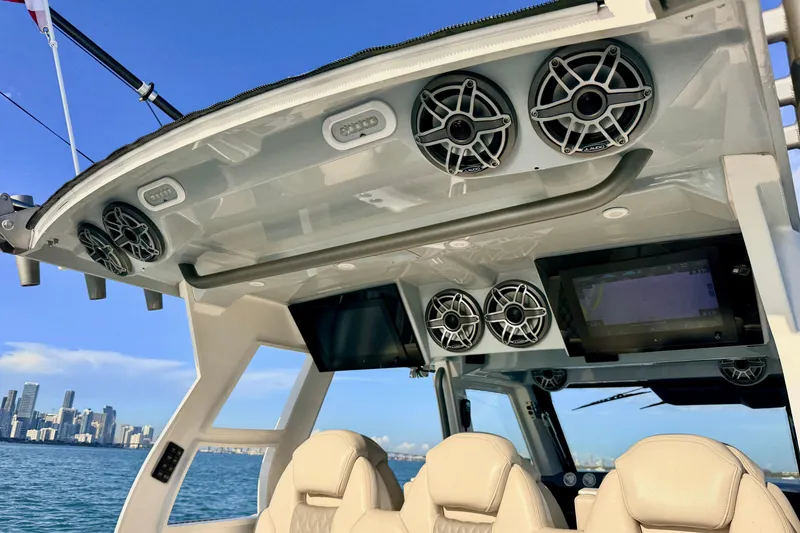 Slide: The Image of 2024 Solace 41 CS boat interior with speakers and navigation screens, city skyline in background. - 25