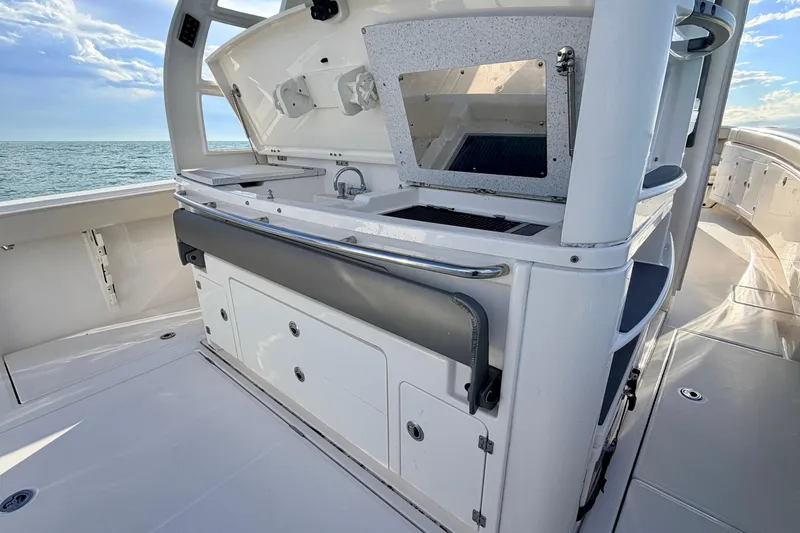 Slide: The Image of 2024 Solace 41 CS boat interior with sleek kitchen and ocean view. - 30