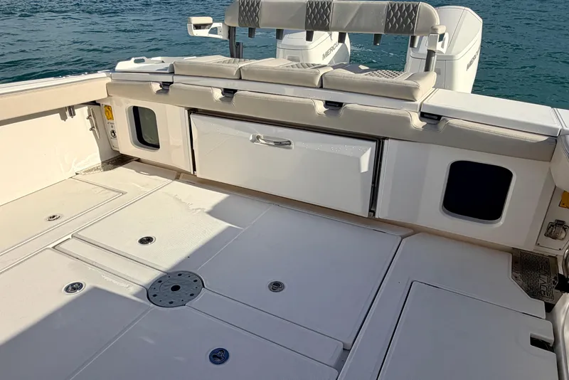 Slide: The Image of 2024 Solace 41 CS boat deck with seating and storage, on calm water. - 33