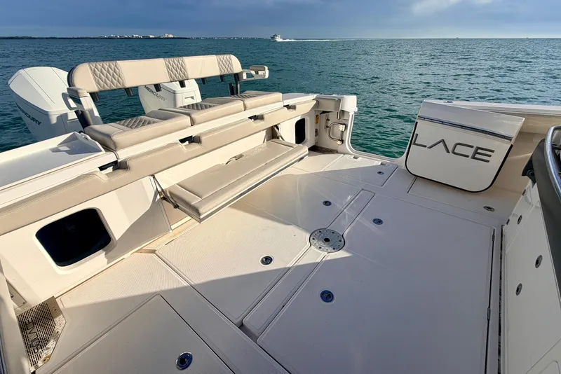 Slide: The Image of 2024 Solace 41 CS boat deck with seating, ocean view, and Mercury engines. - 34