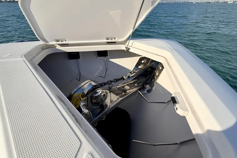 Slide: The Image of Open anchor compartment on 2024 Solace 41 CS boat, showing anchor and chain mechanism. - 40